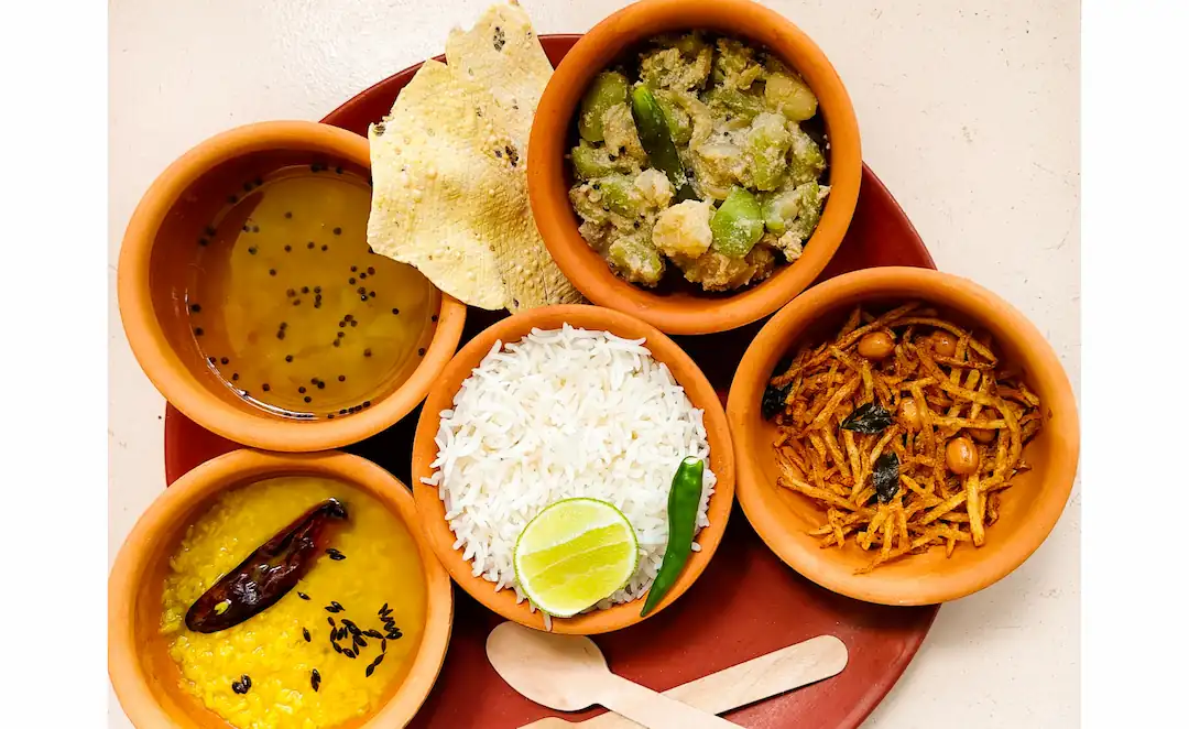 Bengali everyday meal with rice, dal, bhaja, seasonal veg, chutney and papad